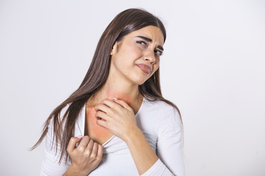 How To Cure Fungal Infection On Skin Naturally At Home In Chicago? young woman scratching her neck due itching gray background female has itching neck concept allergy symptoms healthcare